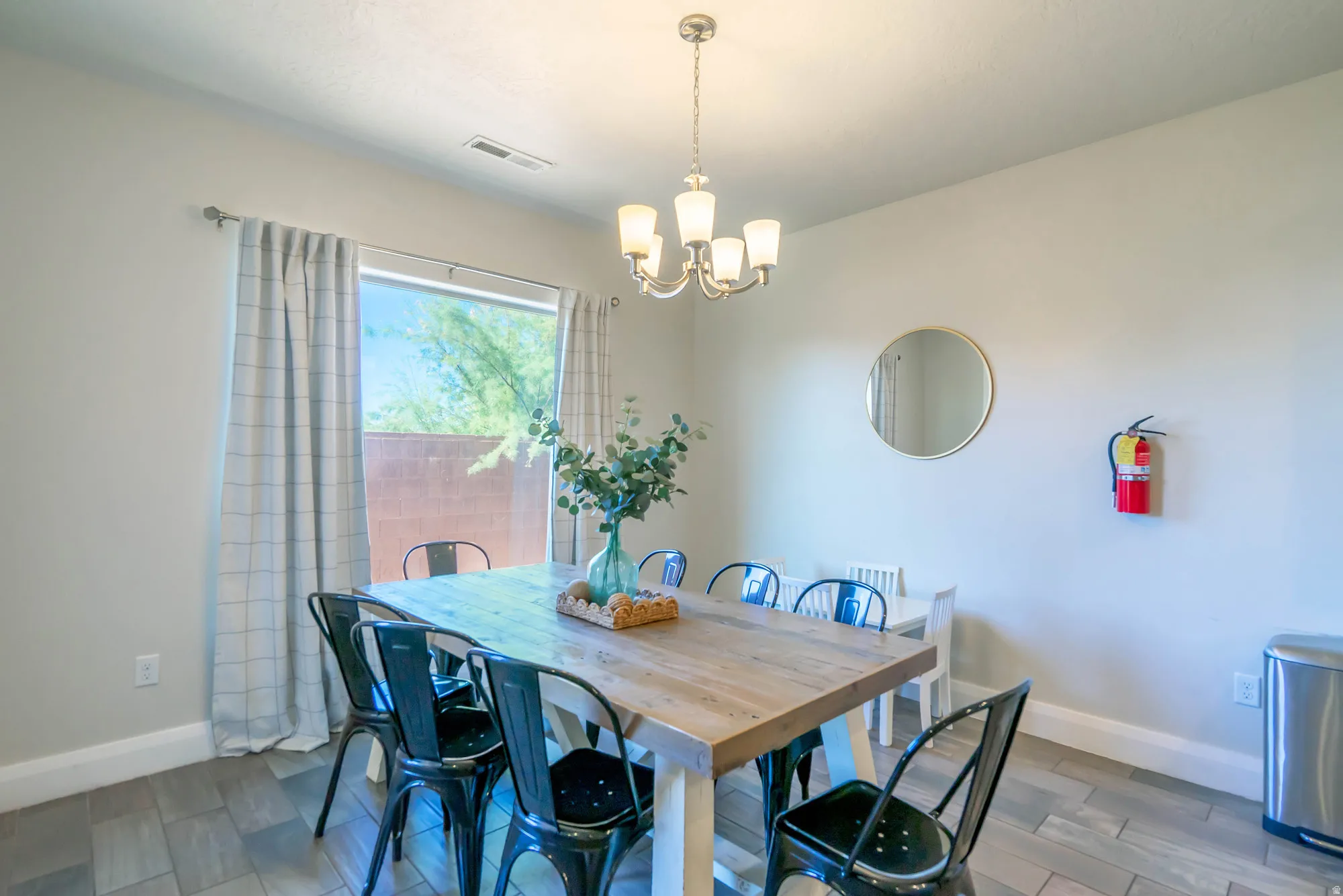 Recessed lighting, wood-finish flooring, and a chandelier with glass shades