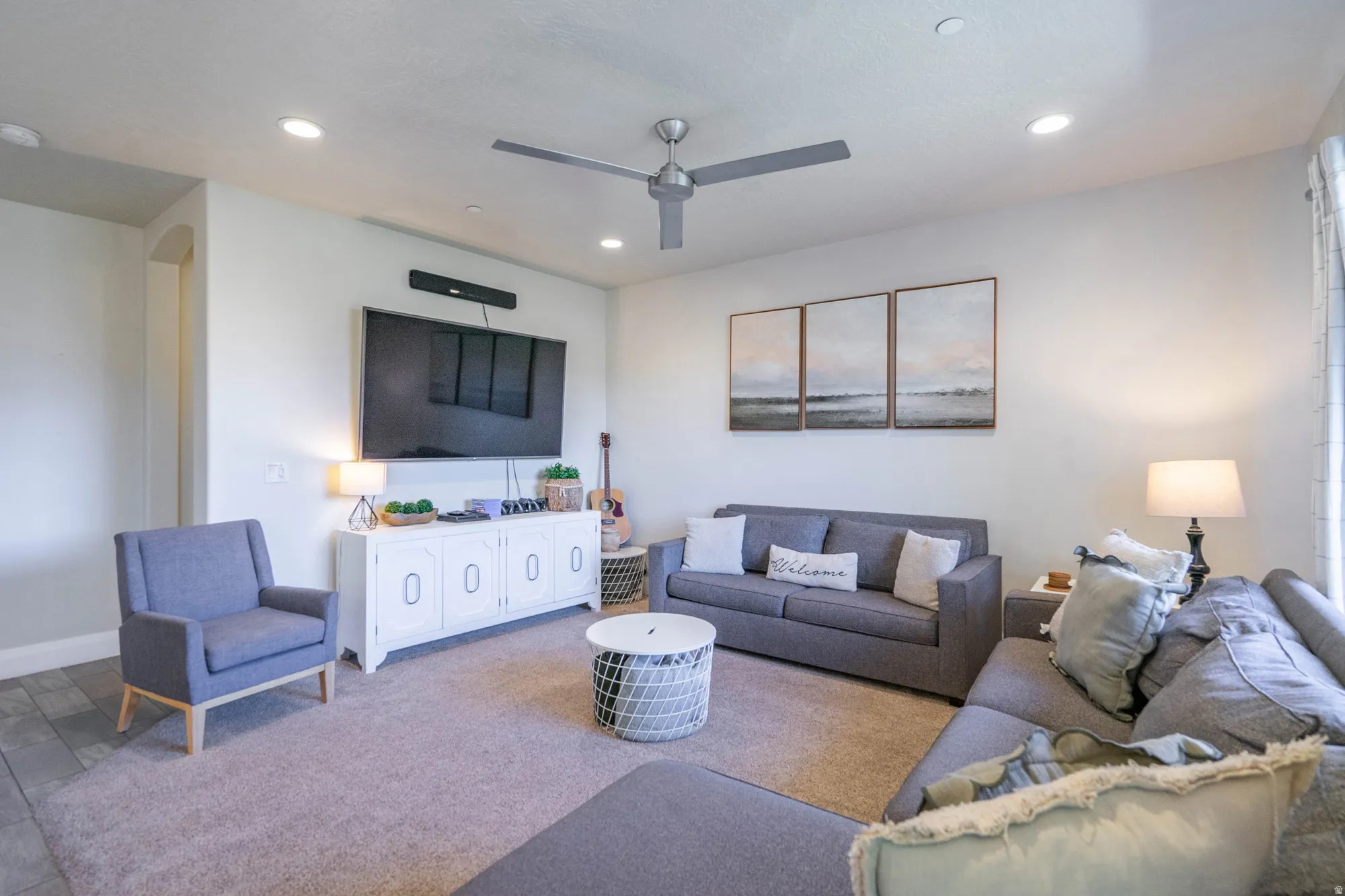 Spacious living area featuring recessed lighting, a ceiling fan, and carpeted flooring