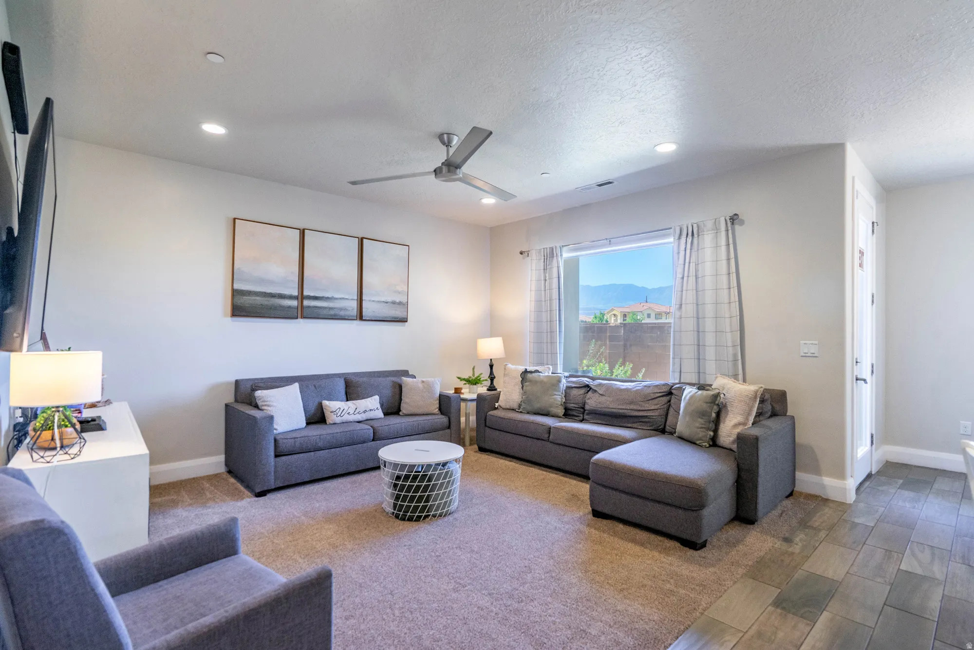 Recessed lighting, ceiling fan, large window, tile flooring, and carpet flooring