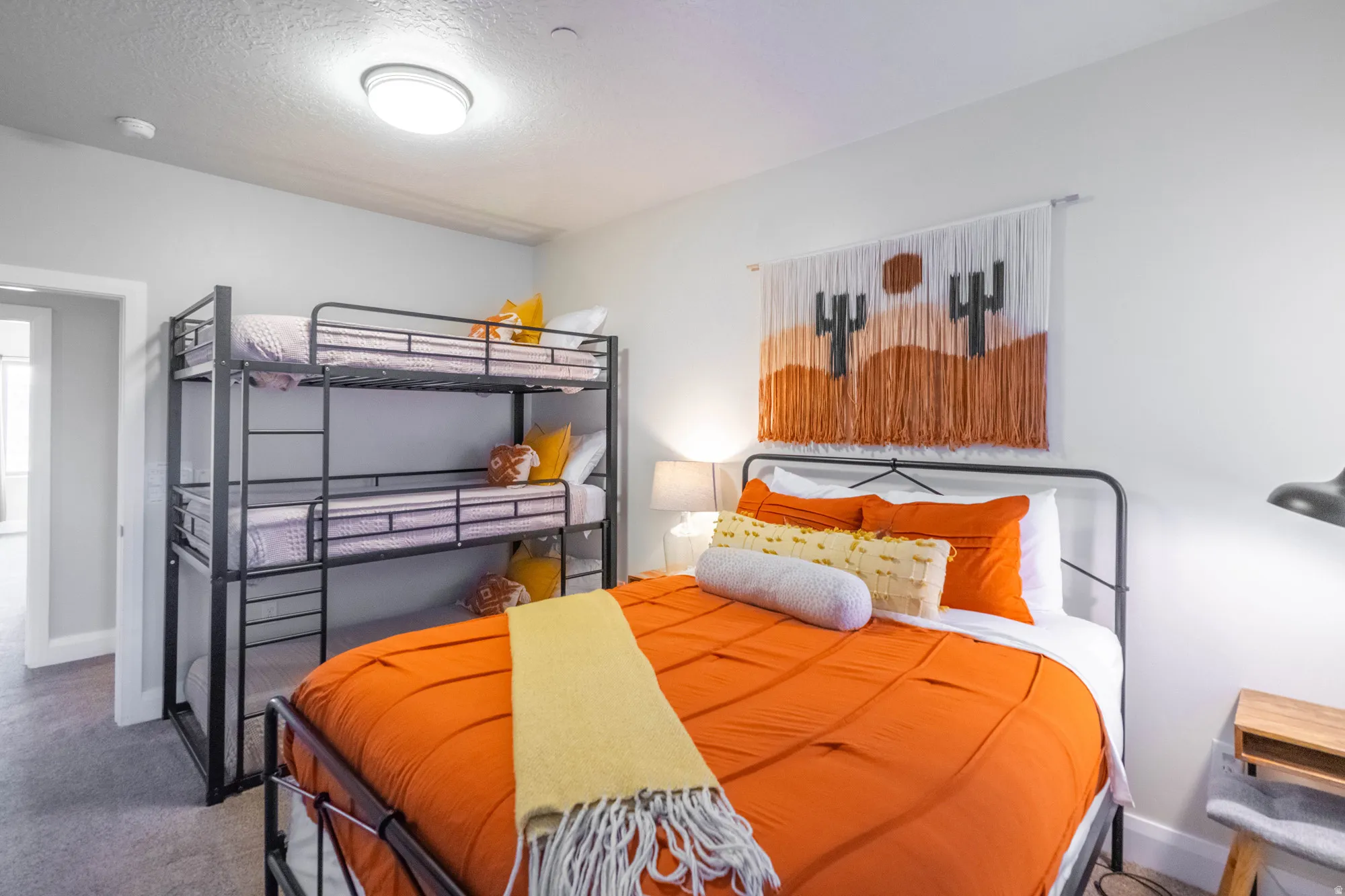 Neutral wall paint, flush mount ceiling light, and gray carpet flooring