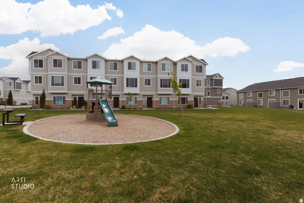 Expansive common green space with a built-in playground structure
