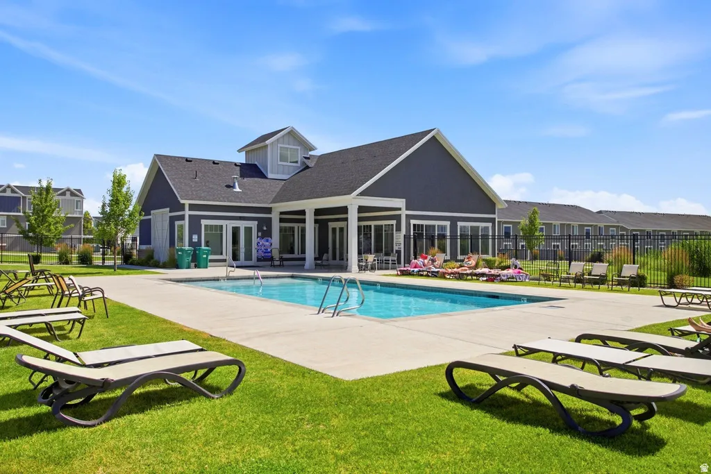 Central clubhouse with a swimming pool and expansive concrete decking