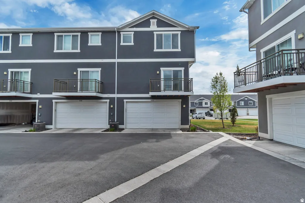 Contemporary multi-story exterior with dark gray siding and white trim