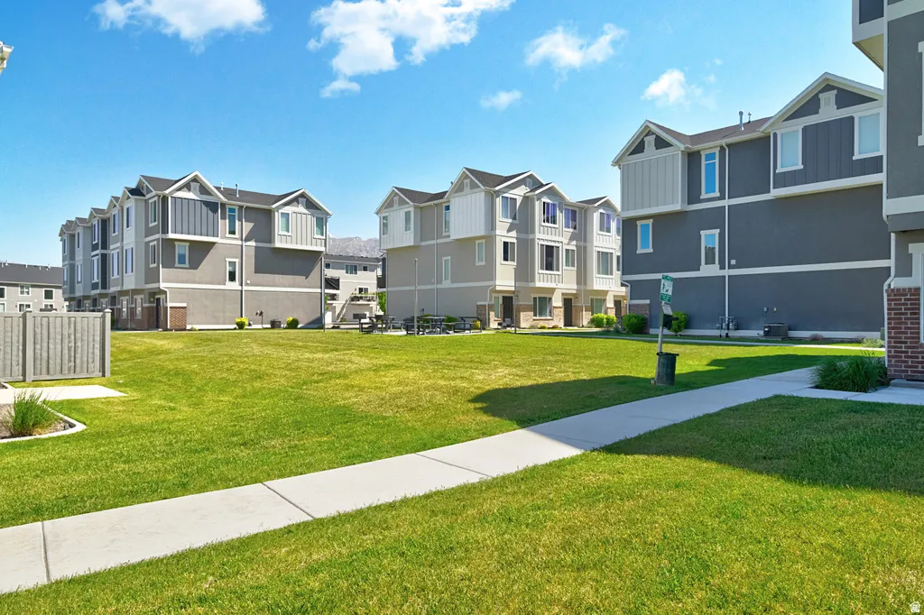 Expansive green space with paved walkways and mature landscaping