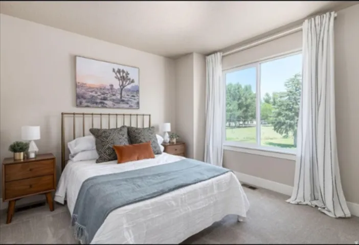 Wall-to-wall carpeting with light-toned walls and a large window