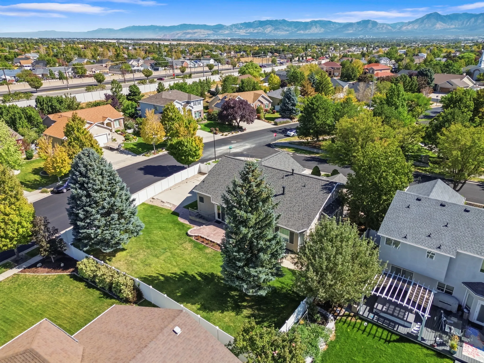 Expansive property featuring a mature landscape, established trees, and a spacious green lawn