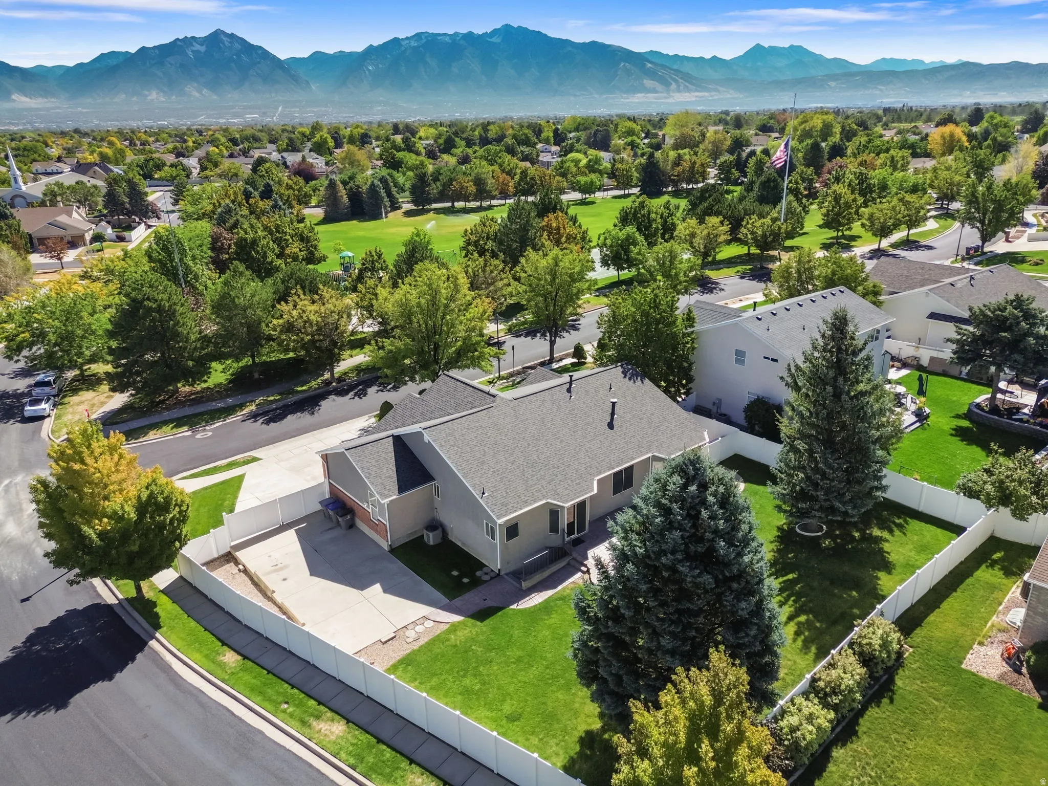 Single-story residence with a composite shingle roof, attached garage, and a concrete driveway