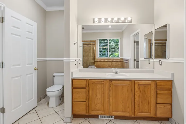 Warm wood cabinetry with a white countertop and integrated sink