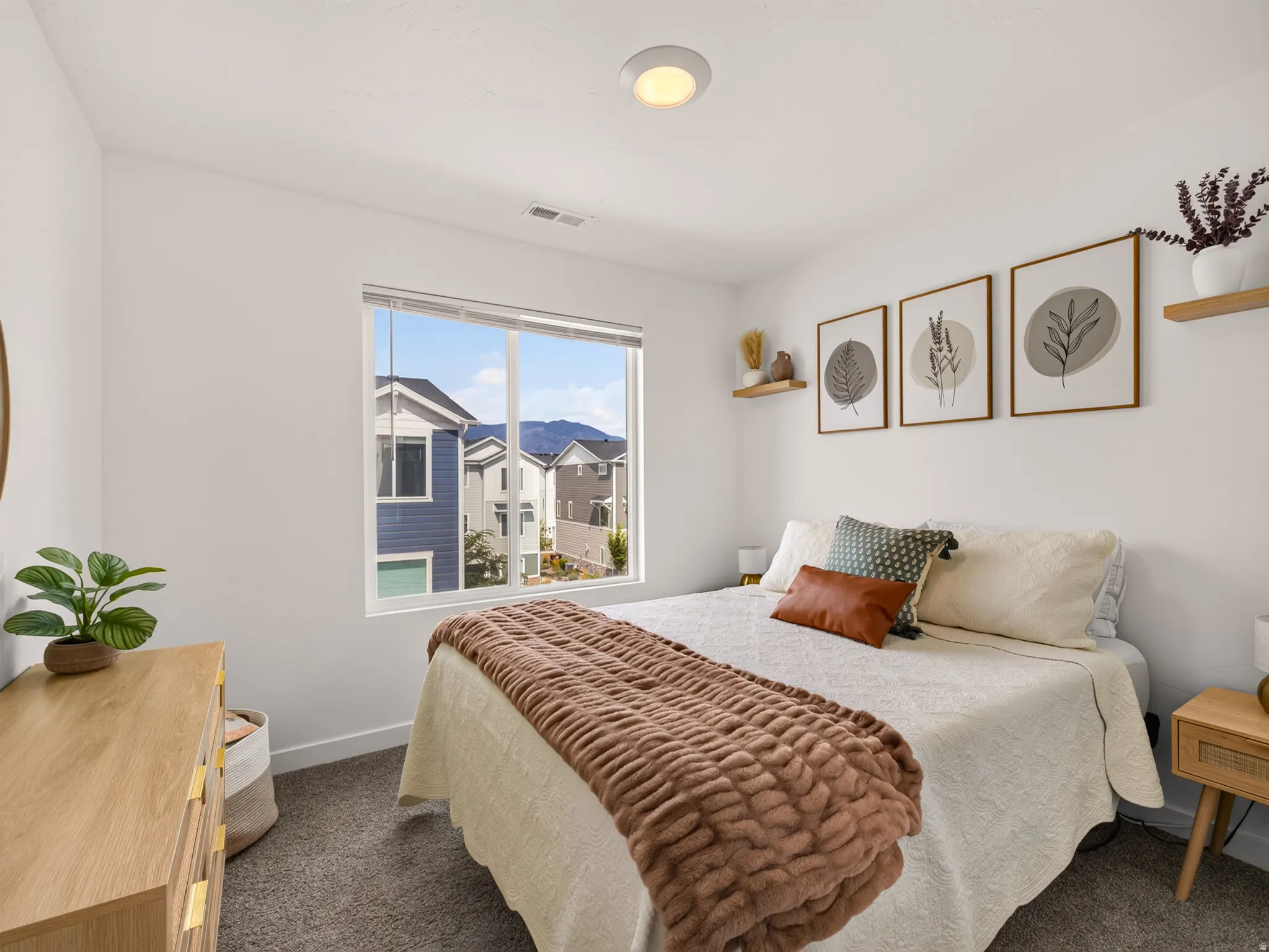 Recessed ceiling lighting, large window, and light gray carpeting