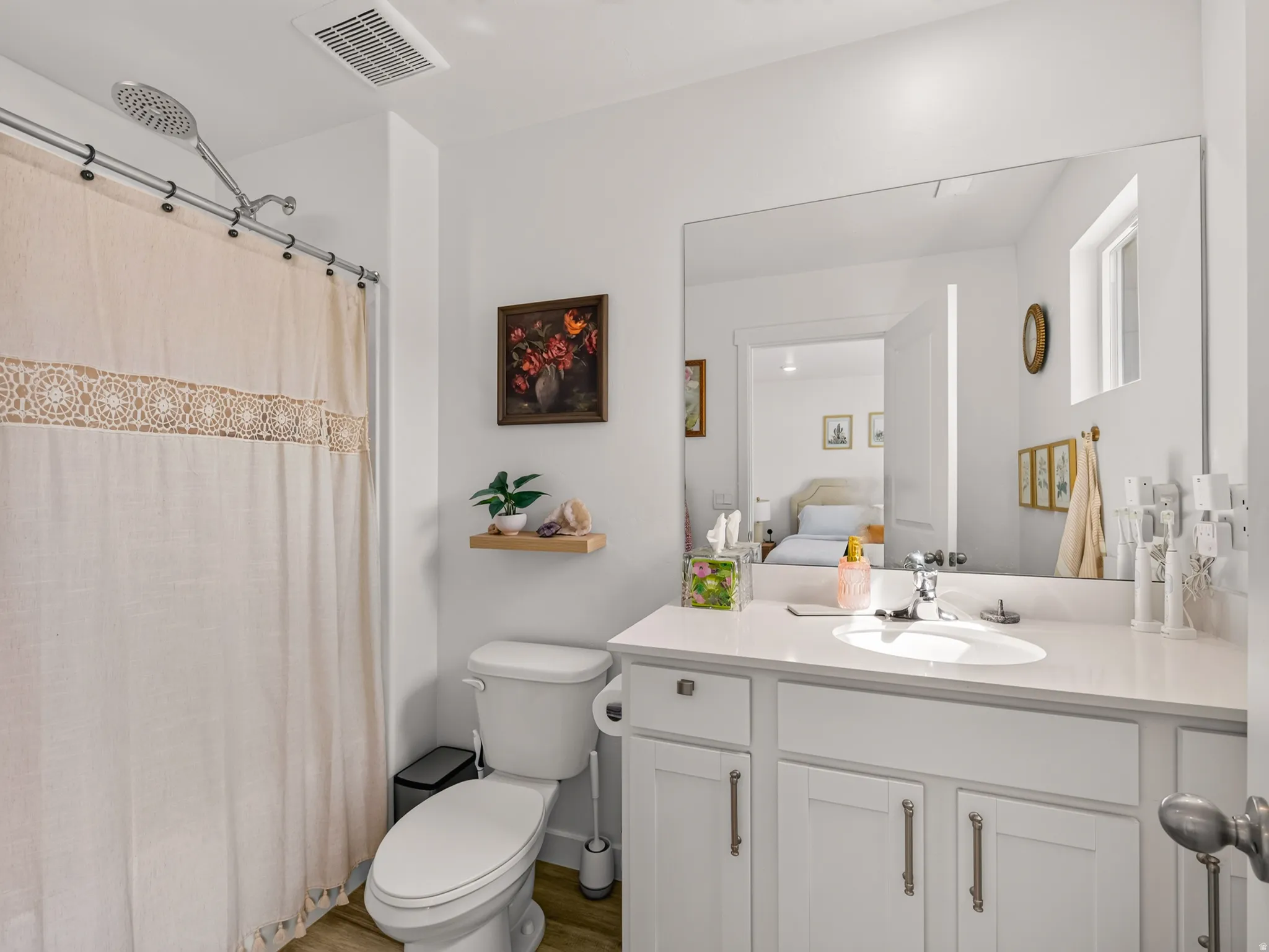 White vanity with integrated sink, chrome faucet, and white countertop