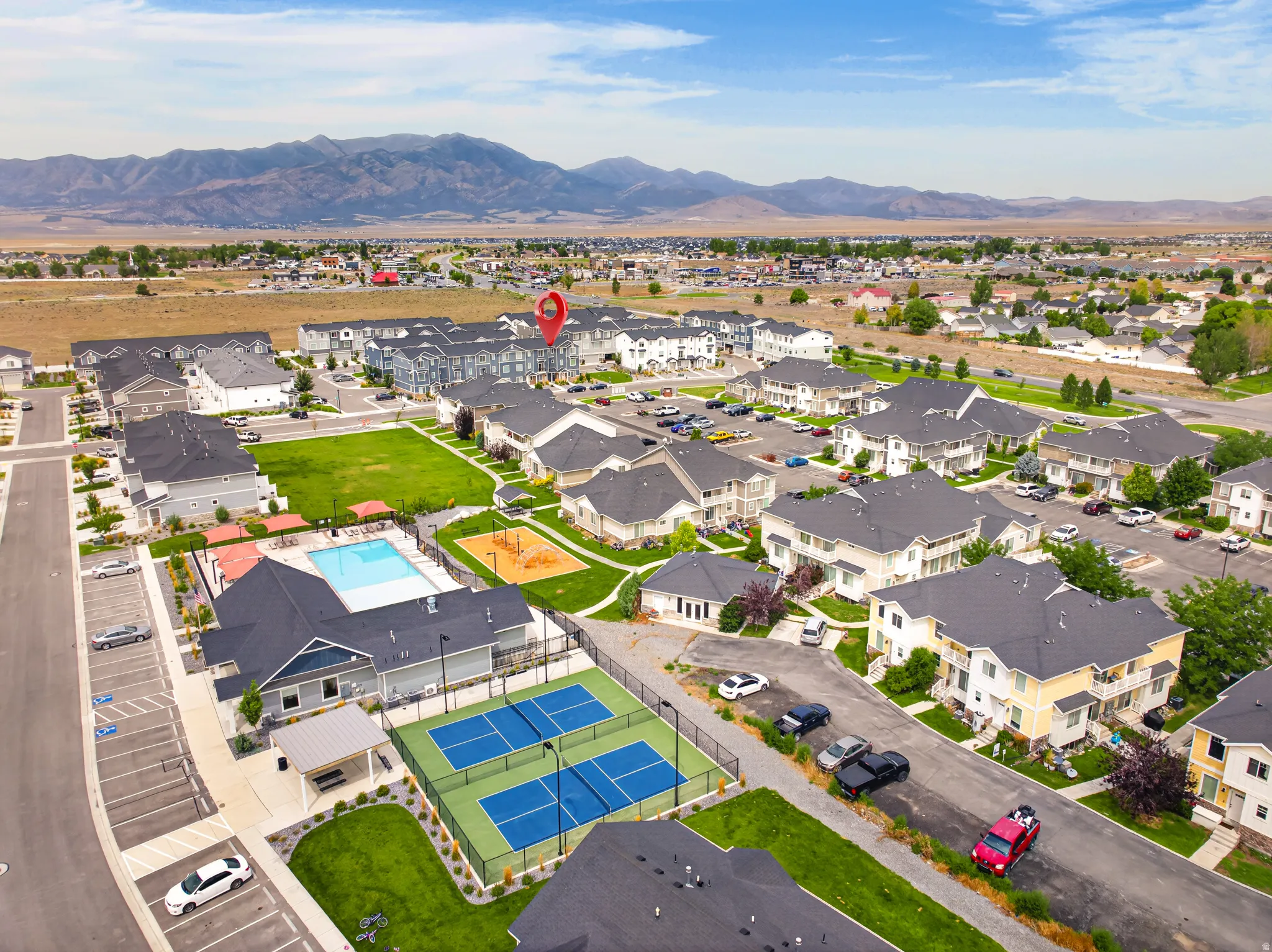 Community features a swimming pool, tennis courts, open greenspace, and mountain backdrop
