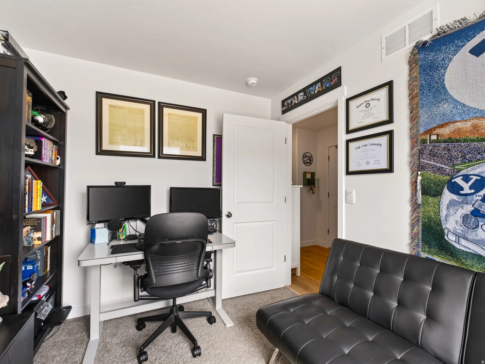 Recessed lighting, light gray carpet, white walls, and a white interior door