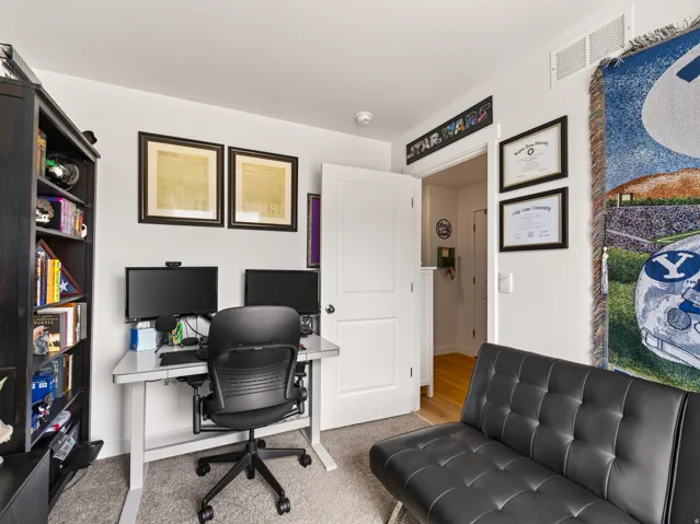 Recessed lighting, light gray carpet, white walls, and a white interior door