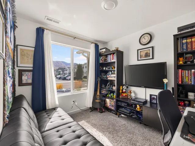 Recessed ceiling lighting, large window with ample natural light, soft carpet flooring, and white painted walls