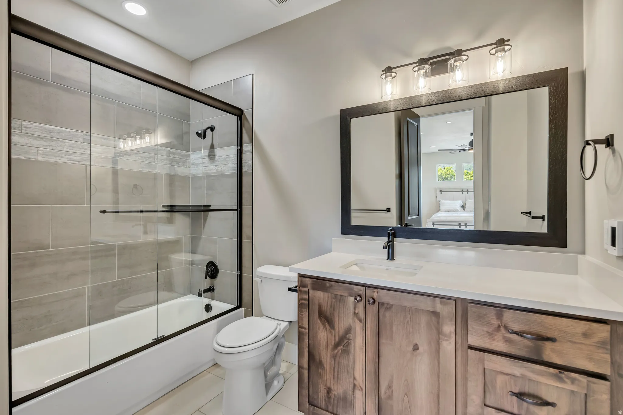 Enclosed tub/shower combination with sliding glass doors and tiled surround