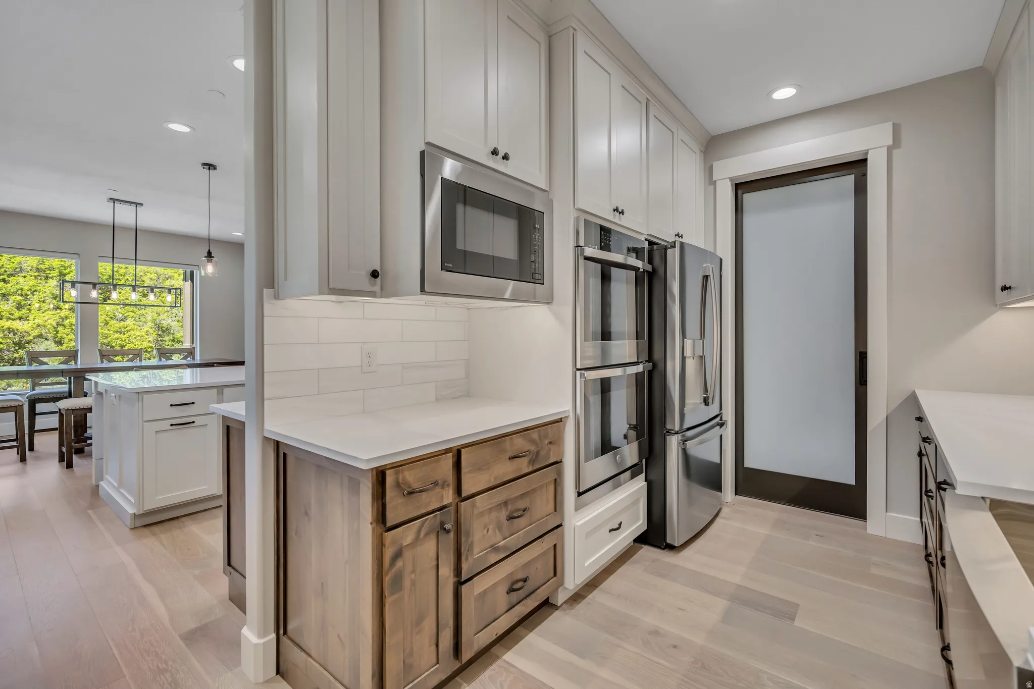 Gourmet kitchen with stainless steel appliances, built-in double oven, and a built-in microwave