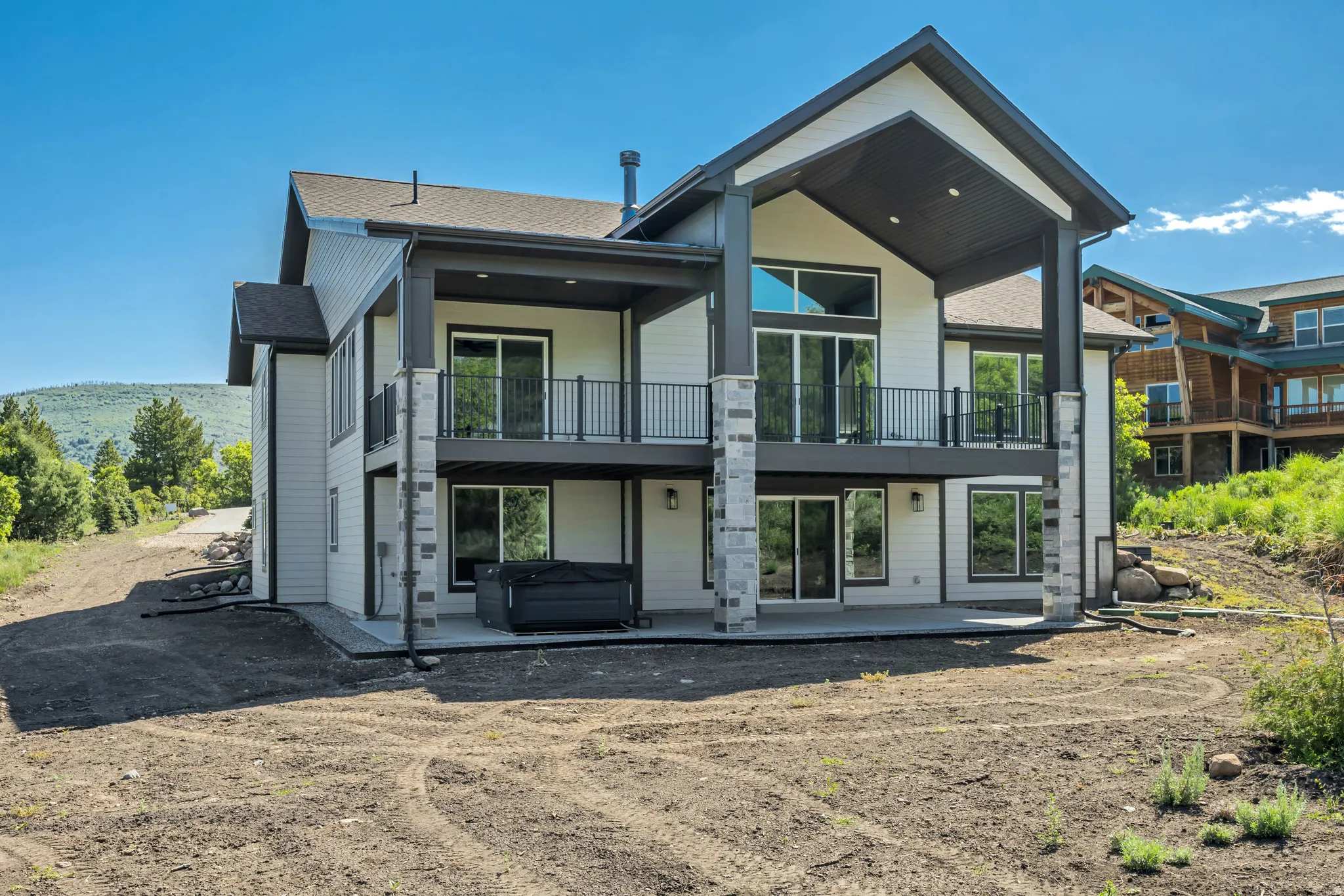 Modern two-story exterior with light siding and dark trim