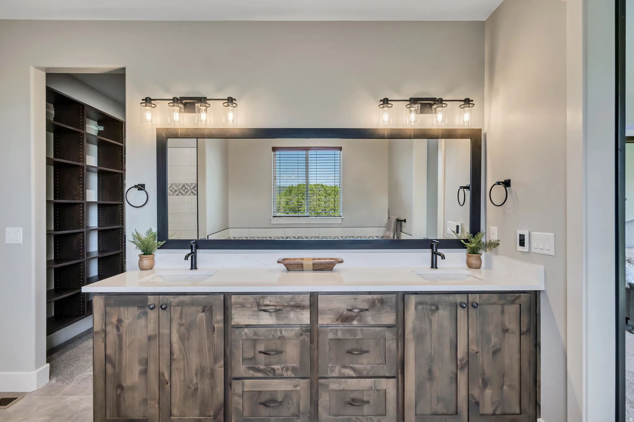 Dual vanity with a white countertop and wood-finish cabinetry