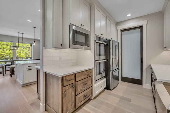 Gourmet kitchen with stainless steel appliances, built-in double oven, and a built-in microwave