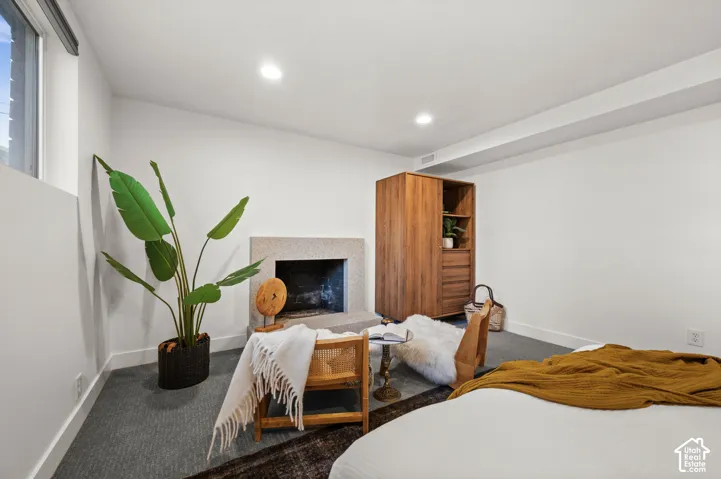 Recessed lighting illuminates the room with a window providing natural light