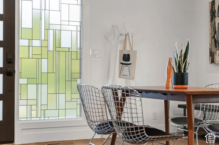 Frosted glass window with geometric pattern, white wall, and light wood-finish flooring