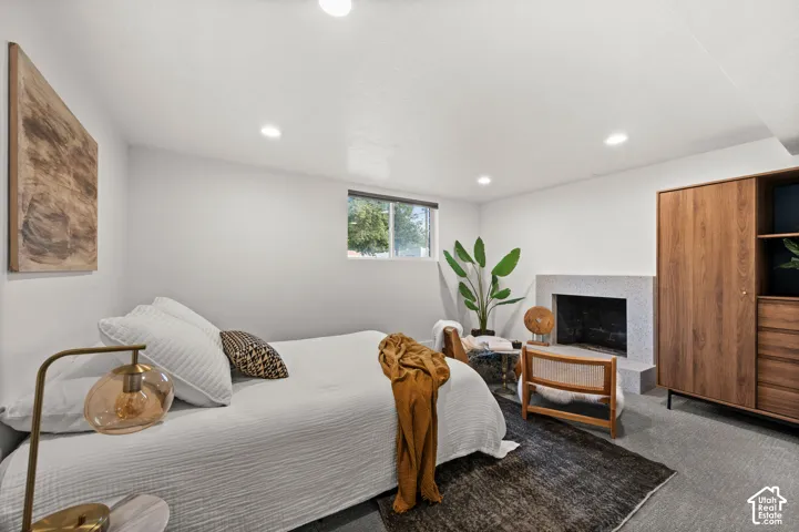 Recessed lighting, a window, and a built-in fireplace with a hearth