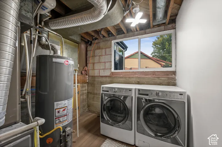 Utility area featuring a window, wood-finish flooring, exposed ceiling joists, and a ceiling-mounted light fixture