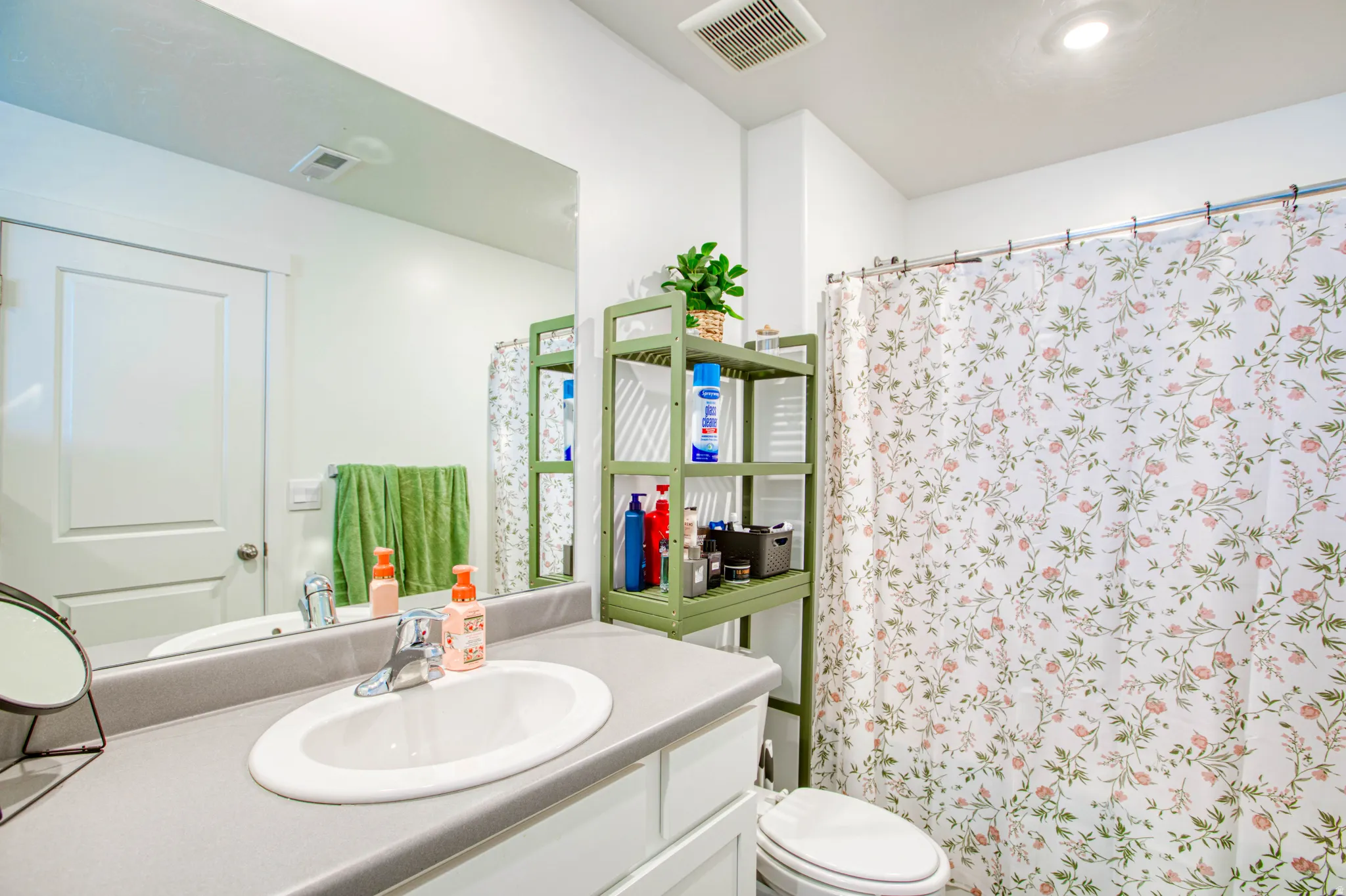 Single basin vanity with a laminate countertop, chrome faucet, and integrated mirror