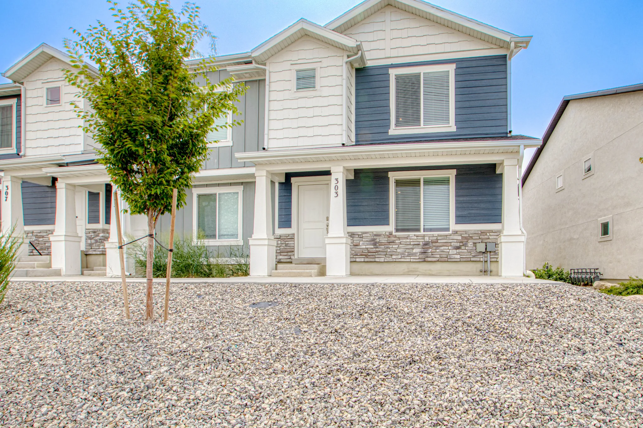 Multi-textured facade featuring horizontal siding and stone veneer