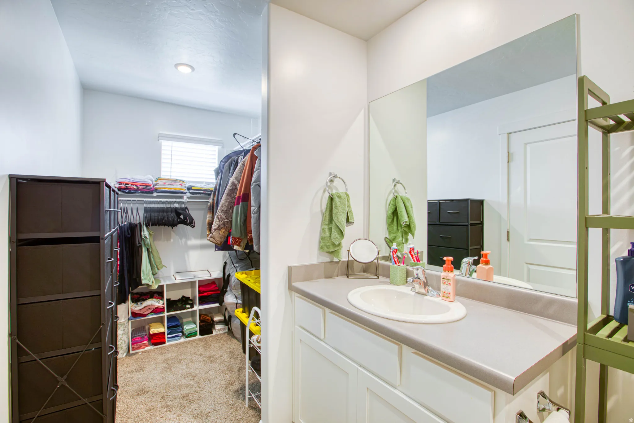 Vanity with an integrated sink and large wall-mounted mirror