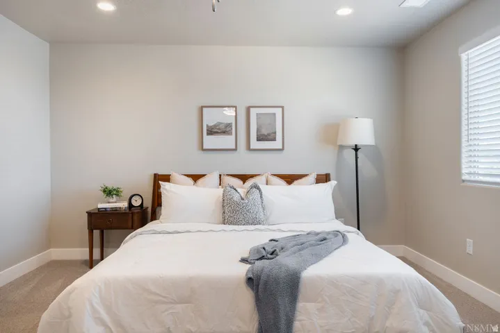 Recessed ceiling lighting, window with blinds, light-toned wall paint, and carpeted flooring