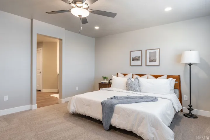 Plush carpet flooring, recessed lighting, and a ceiling fan with integrated lighting