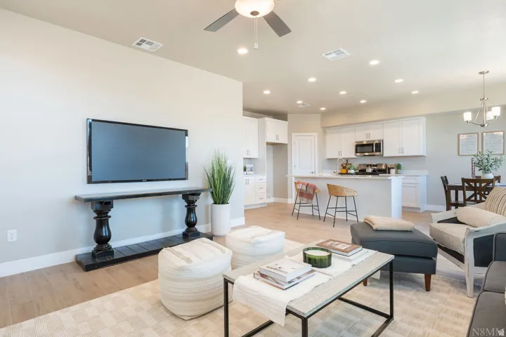 Open-concept living area featuring hardwood flooring, recessed ceiling lighting, and a ceiling fan
