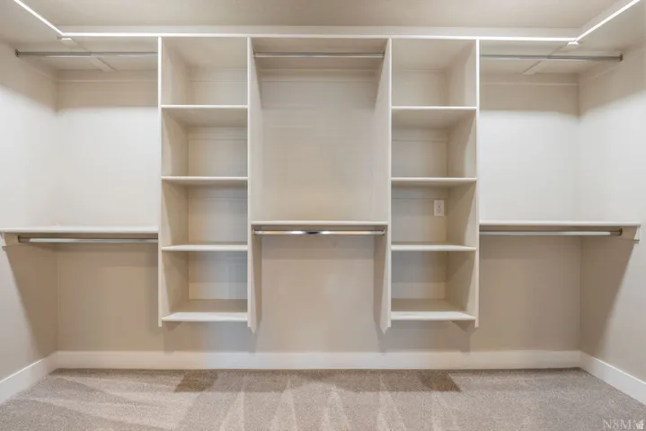 Built-in closet organization system with shelving and hanging rods