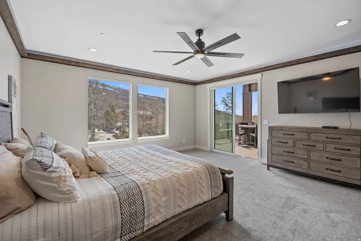Recessed lighting, wood-finish trim, and a ceiling fan with integrated lighting