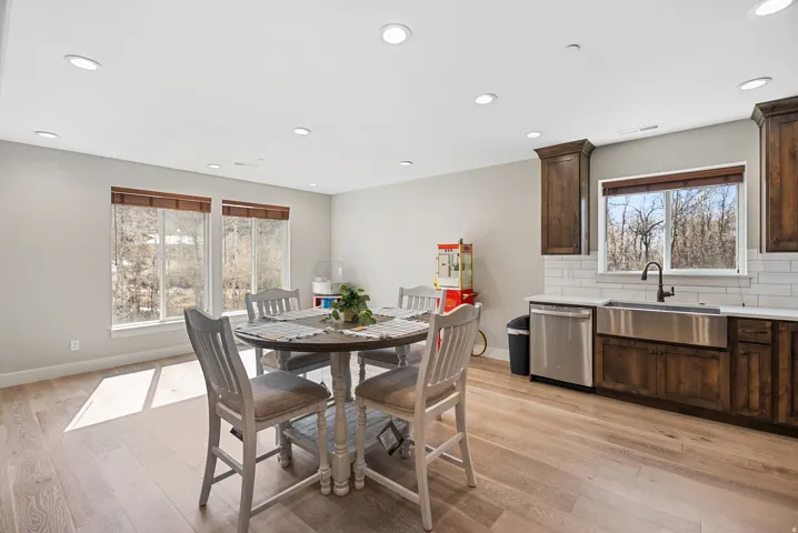 Recessed ceiling lighting illuminates wood-finish flooring