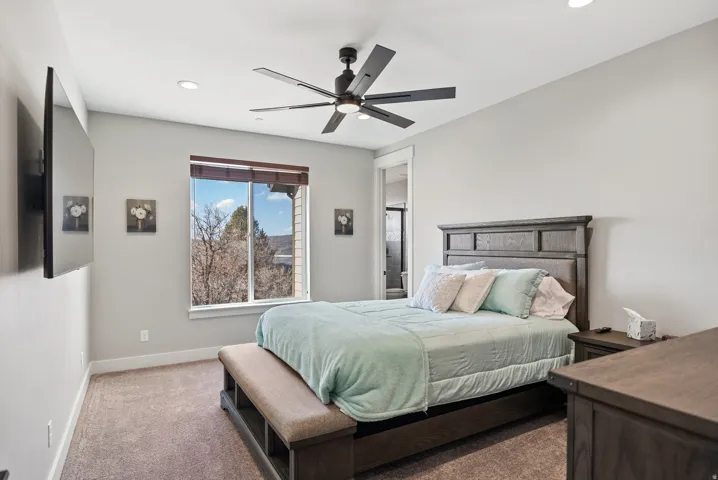 Recessed lighting, wood-finish window treatments, ceiling fan, and carpeted flooring
