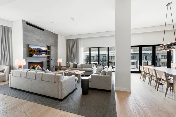 Open-concept living and dining areas featuring light wood-finish flooring