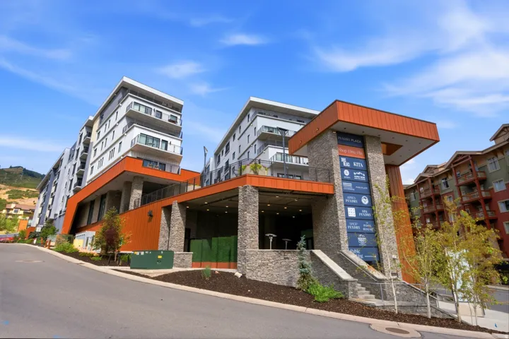 Multi-level building with stone and wood-look paneling accents