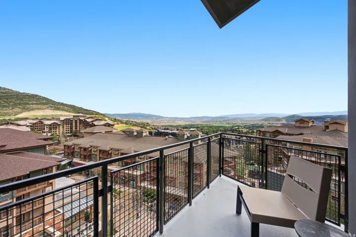 Balcony with metal railing and expansive mountain scenery