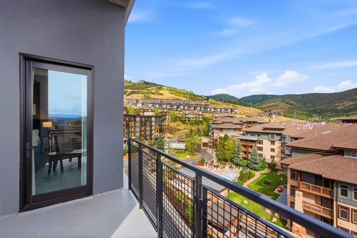 Private balcony with a metal railing and sliding glass door