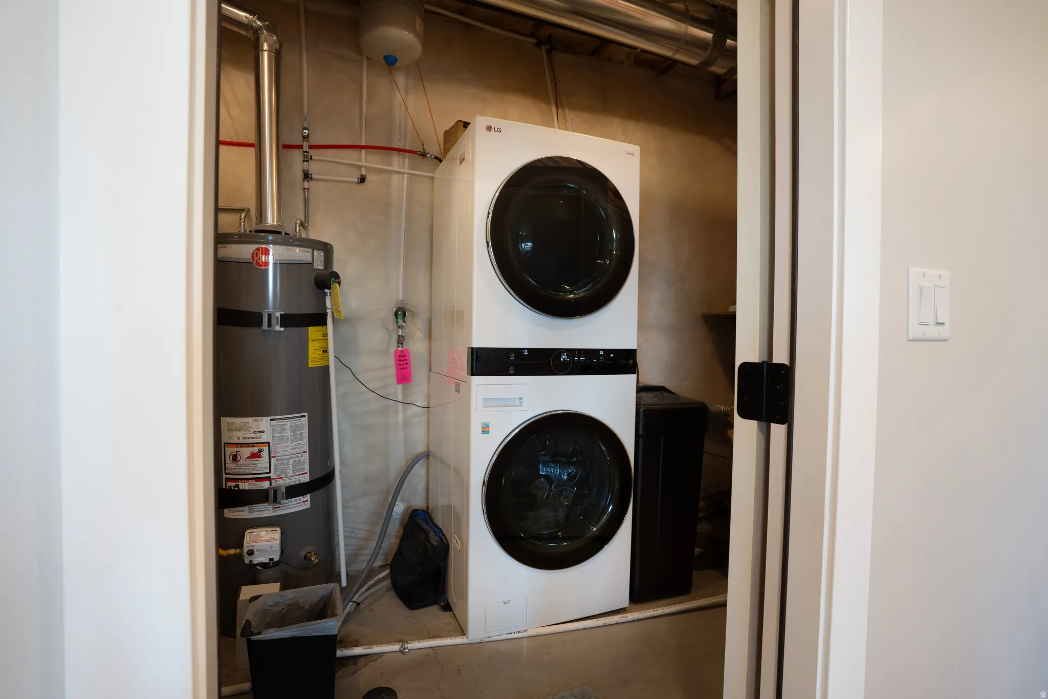 Stacked laundry appliances within a utility closet