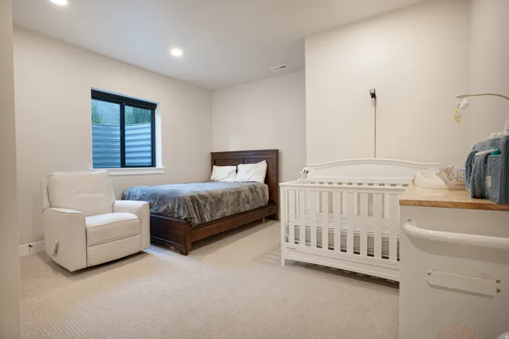Neutral tone wall finish with recessed lighting and carpeted flooring