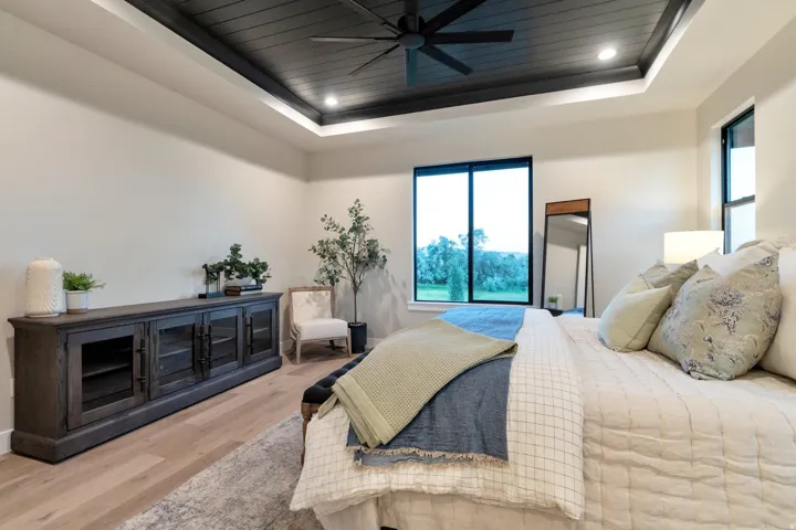 Coffered ceiling with dark wood-finish planks, recessed lighting, and a ceiling fan