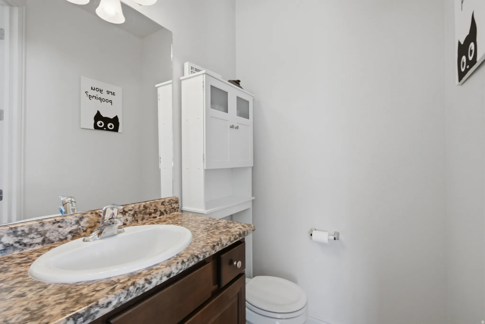 Vanity with a granite-style countertop and an integrated oval sink