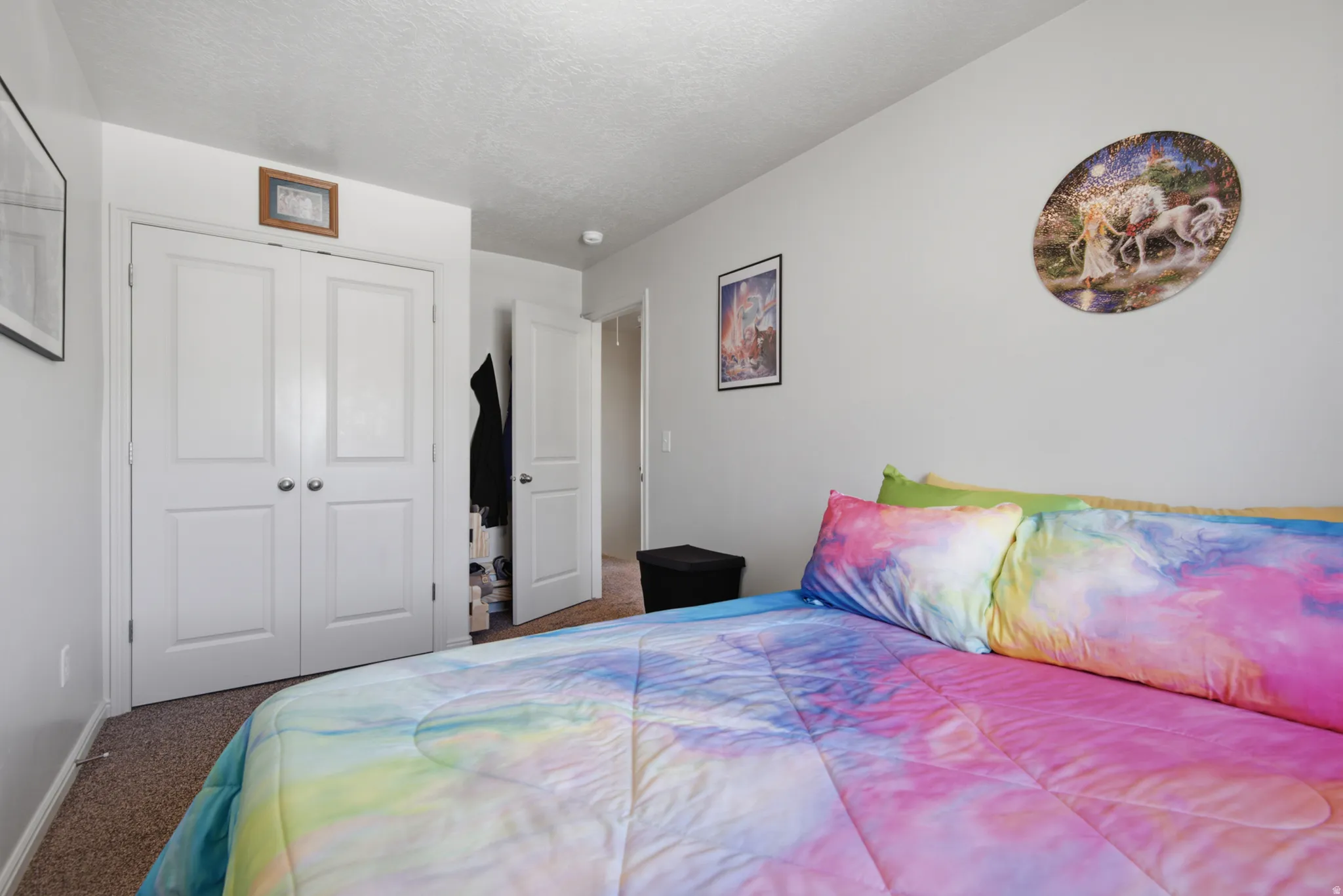 Neutral wall color, wall-to-wall carpeting, and white bi-fold closet doors