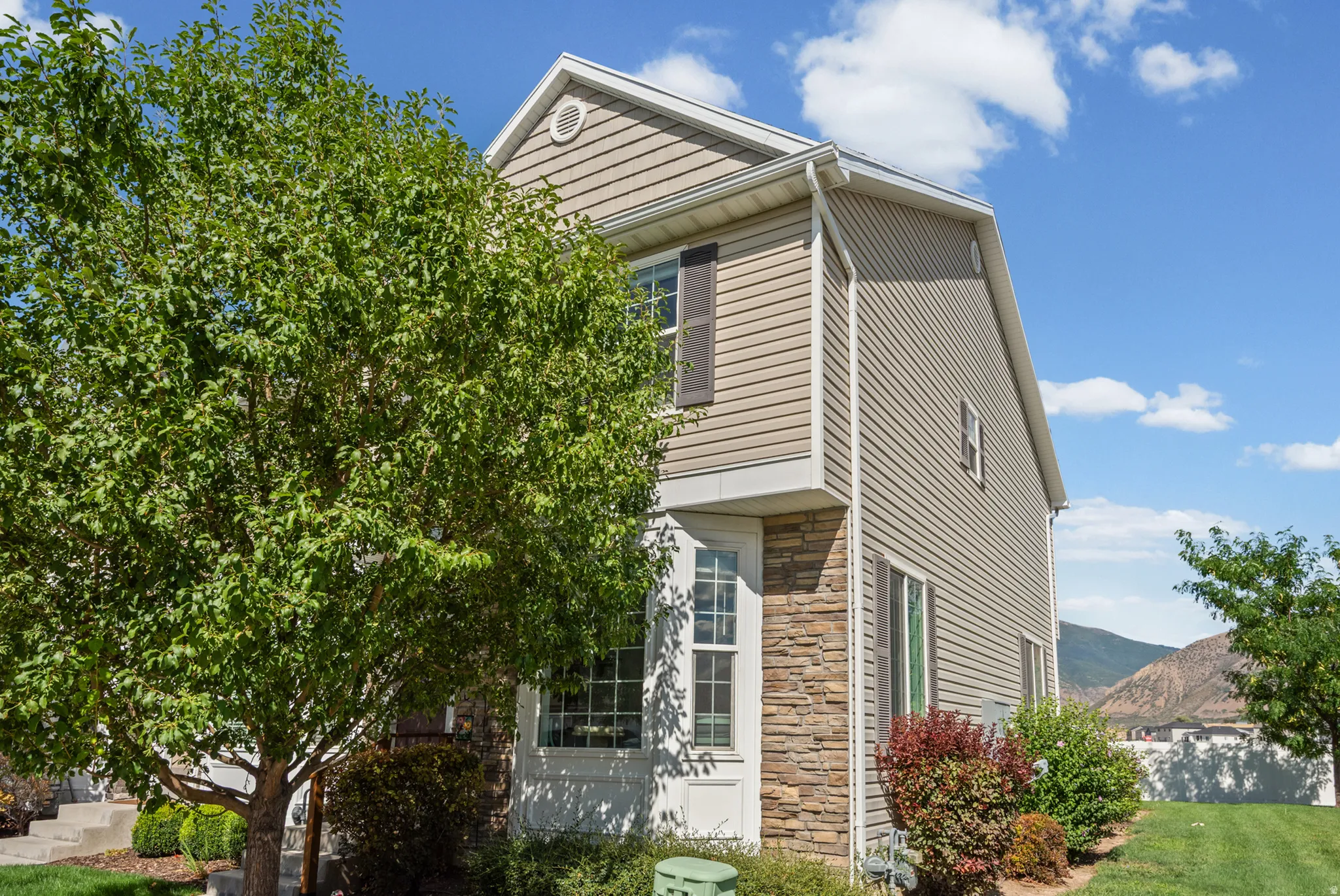 Exterior featuring stone veneer and horizontal siding