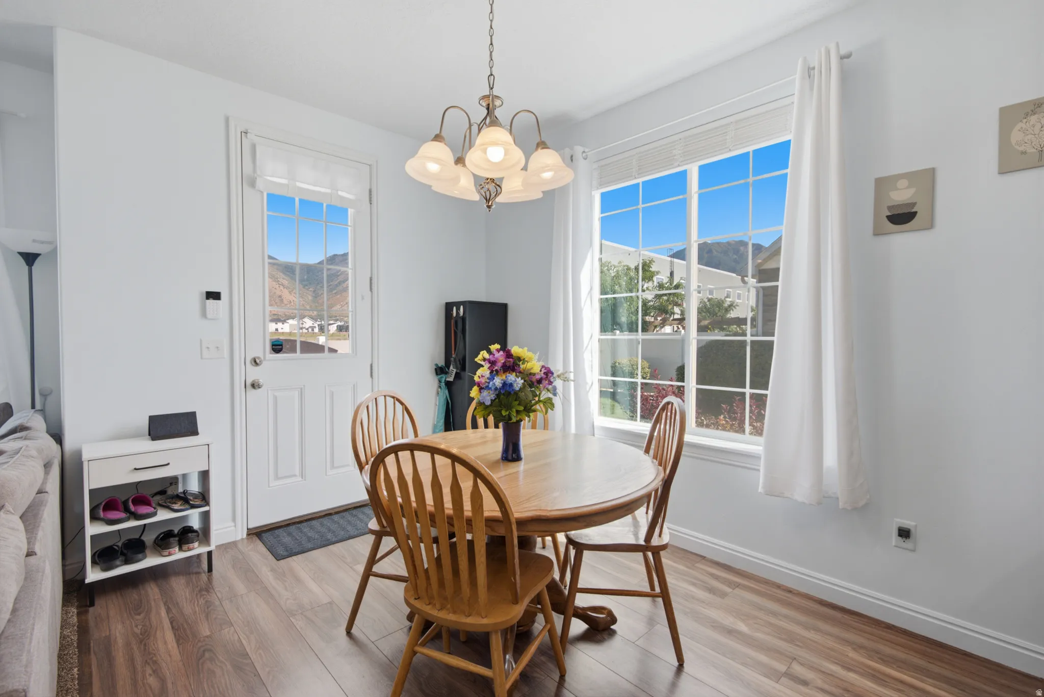 Wood-finish flooring throughout, complemented by a multi-pane glass door and a large multi-pane window