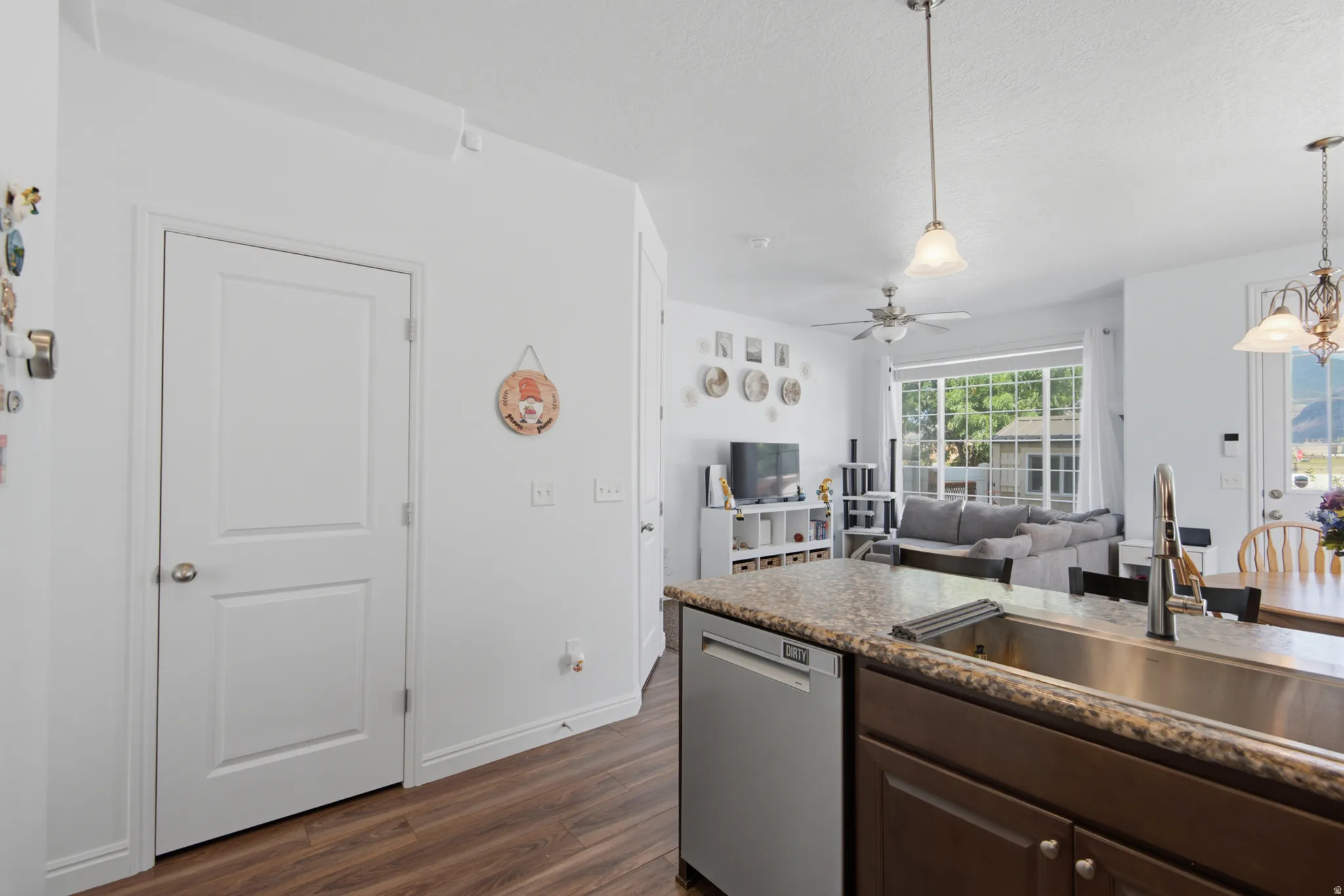 Kitchen island with a stainless steel sink, gooseneck faucet, and granite-style countertop