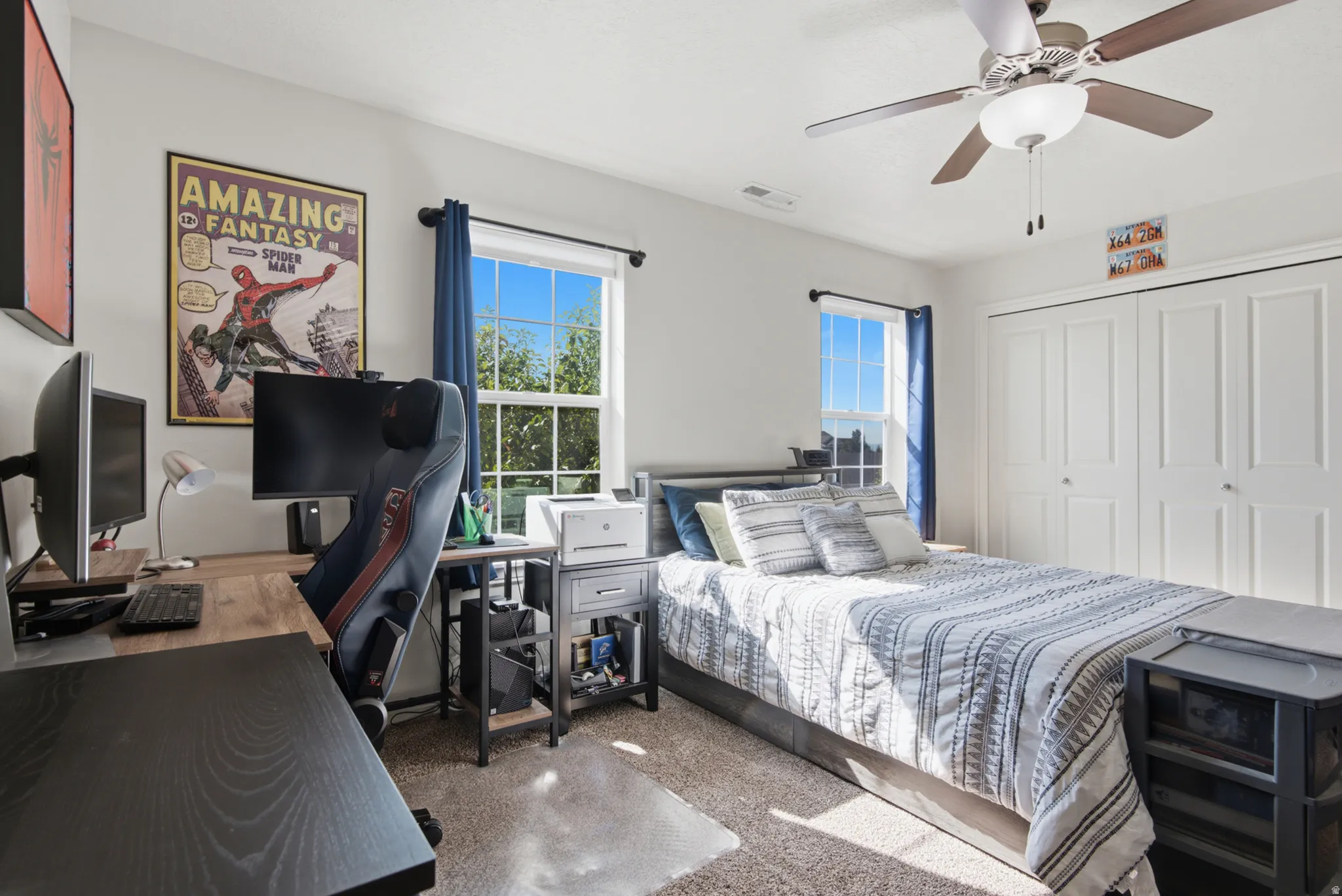 Carpet flooring, multiple windows, ceiling fan with integrated lighting, and bi-fold closet doors